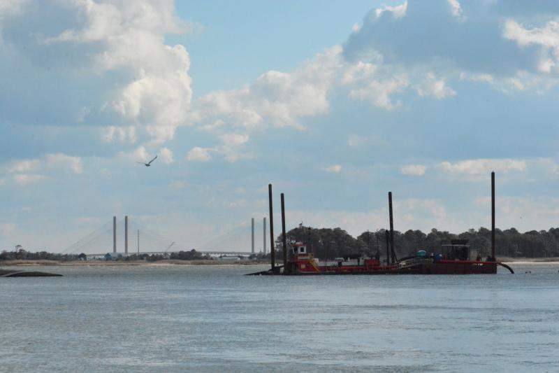 With the spires of the Indian River Inlet bridge in the background, the dredging vessel for contractor J.F. Brennan Construction works its way through Massey’s Ditch. The dredging of the popular waterway started the week of Jan. 6. CHRIS FLOOD PHOTOS